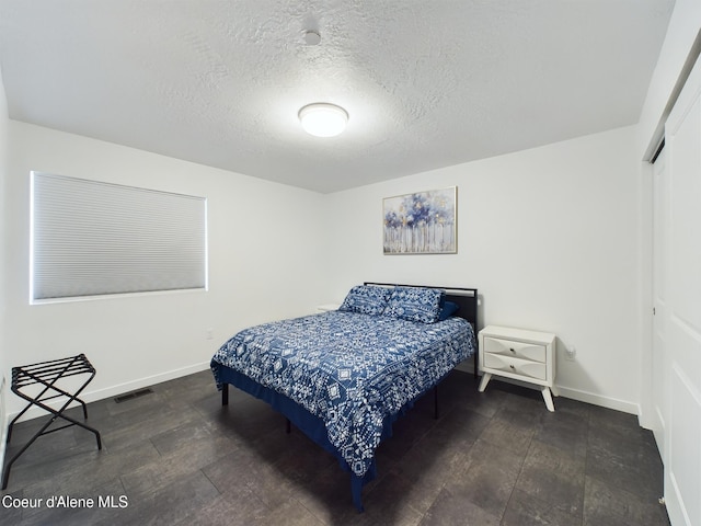 bedroom featuring a closet and a textured ceiling