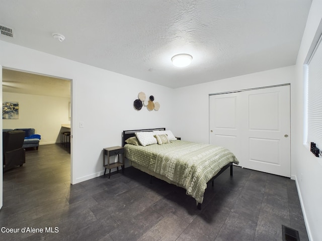 bedroom featuring a textured ceiling and a closet