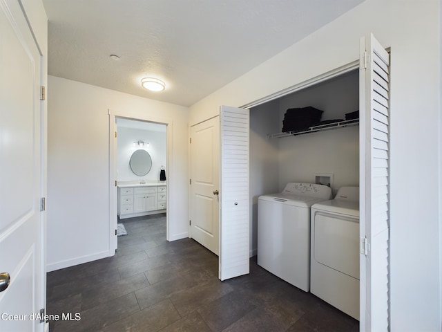 clothes washing area with a textured ceiling and washing machine and clothes dryer