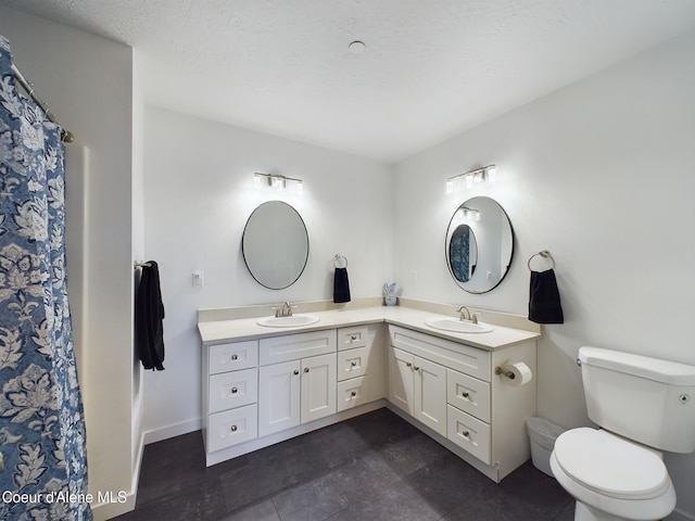 bathroom featuring tile patterned flooring, vanity, and toilet