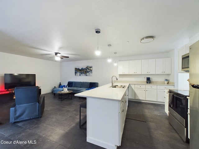 kitchen with ceiling fan, sink, hanging light fixtures, white cabinets, and appliances with stainless steel finishes