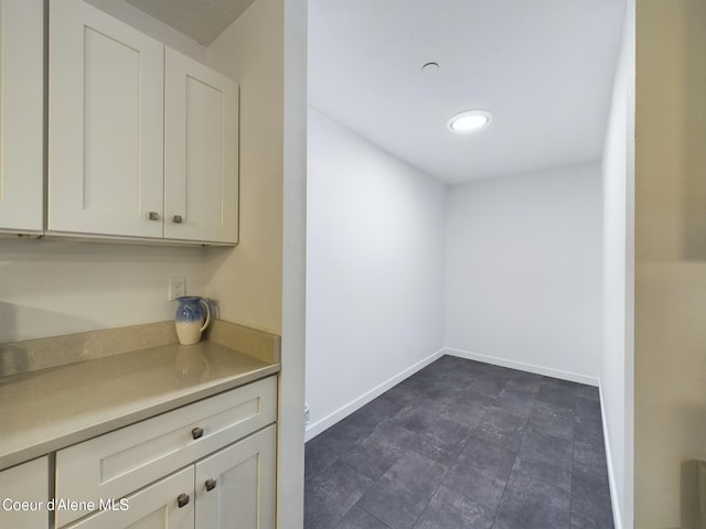 bar featuring white cabinetry