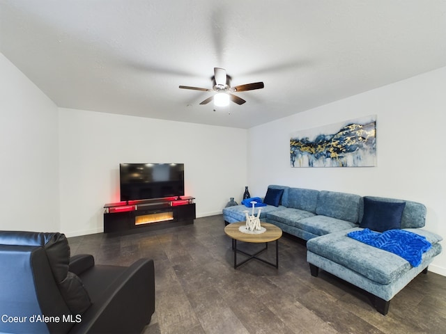 living room with ceiling fan and dark hardwood / wood-style flooring