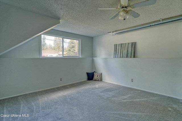 additional living space with ceiling fan, carpet floors, and a textured ceiling