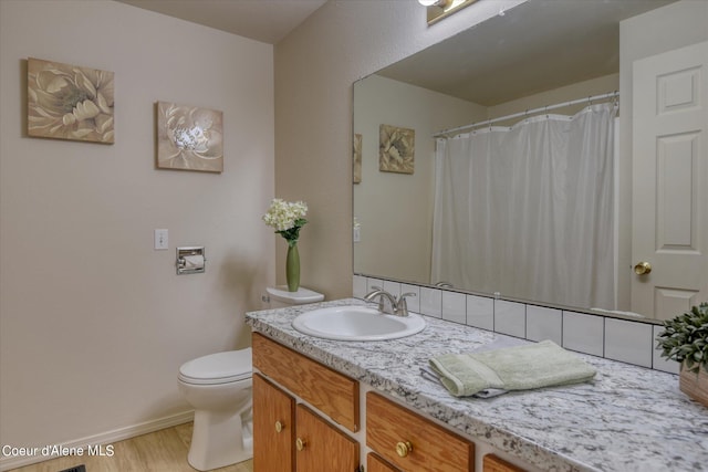 bathroom with vanity, hardwood / wood-style flooring, and toilet