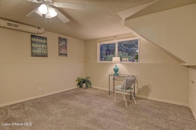 interior space with ceiling fan, light colored carpet, and a textured ceiling