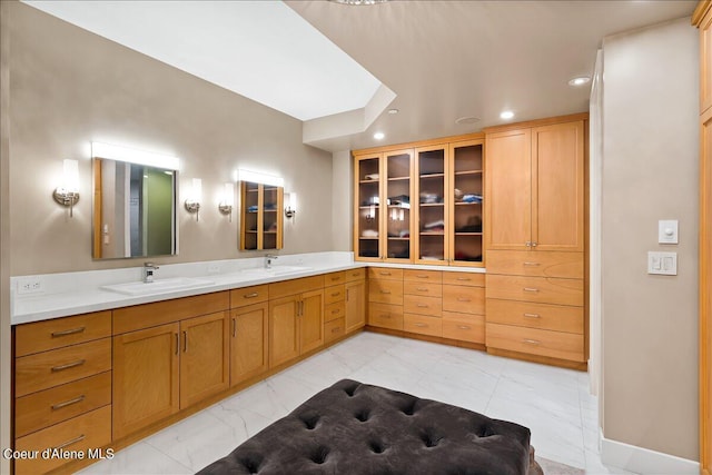 bathroom featuring vanity and a skylight