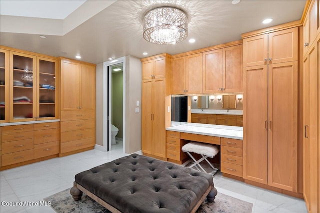 kitchen featuring built in desk and light brown cabinets