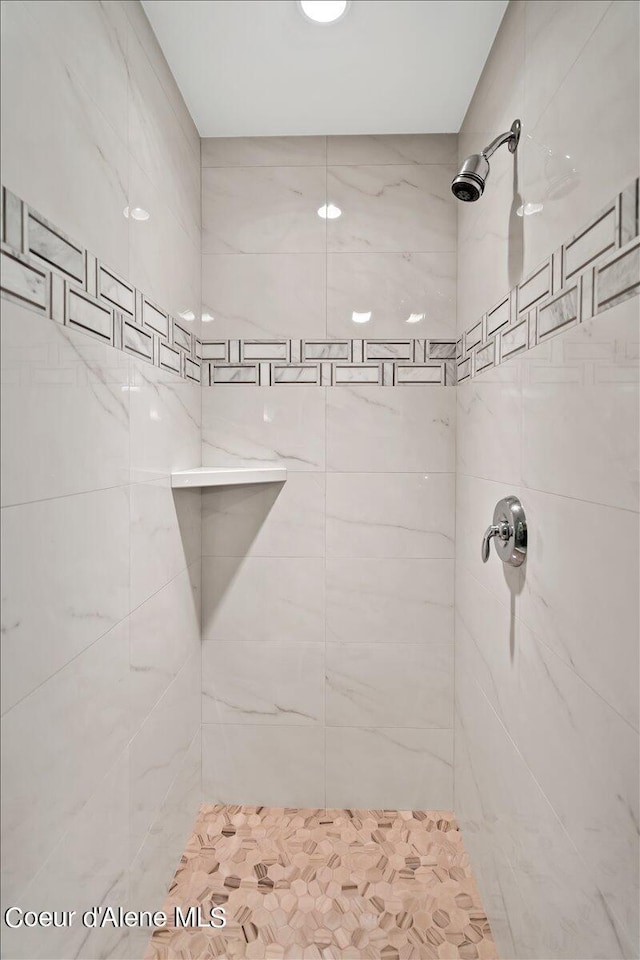 bathroom with a tile shower