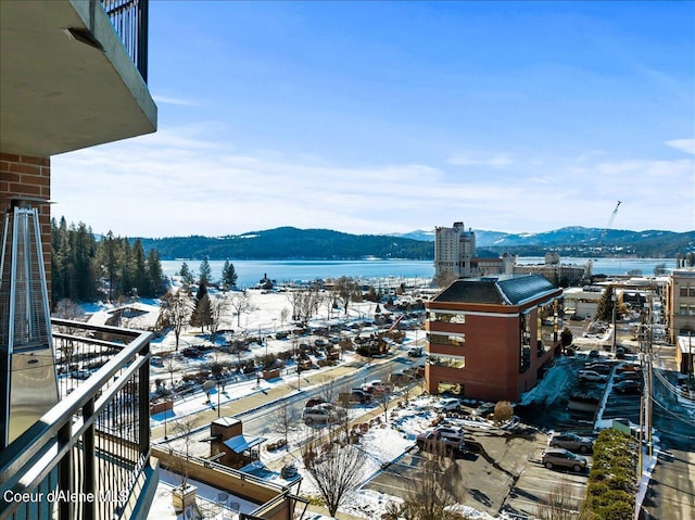 property's view of city with a water and mountain view