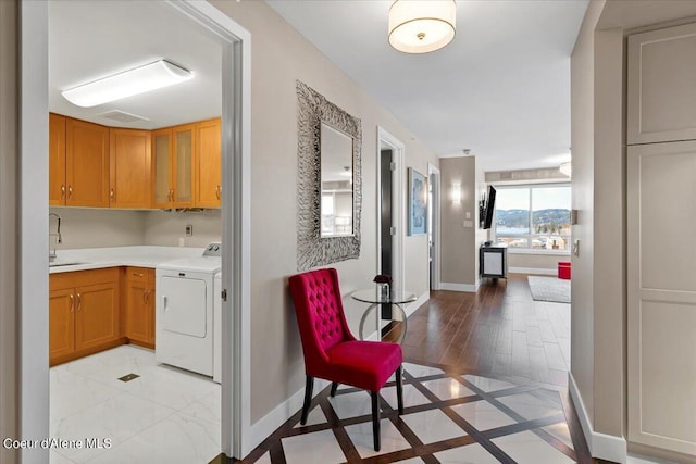 interior space featuring sink and washer and clothes dryer