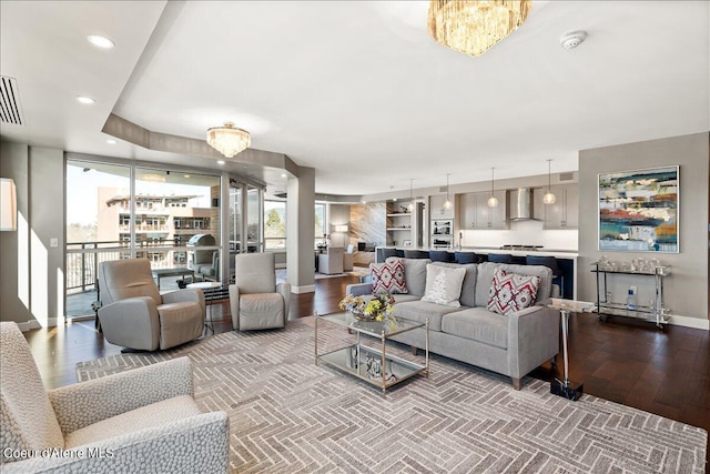 living room featuring an inviting chandelier and wood-type flooring