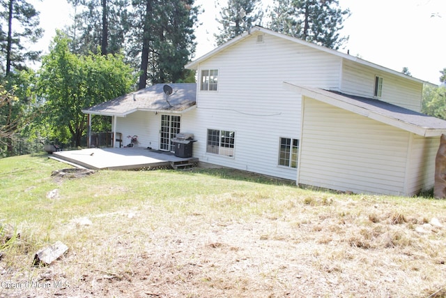 rear view of property with a yard and a wooden deck