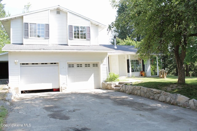 view of front of property featuring a garage and a front lawn