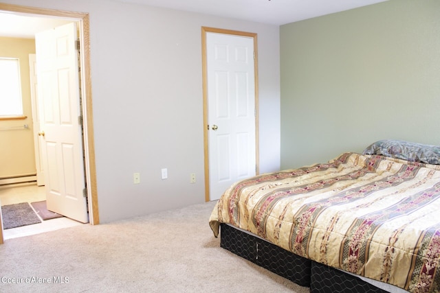 bedroom featuring a baseboard radiator and carpet flooring