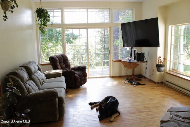 living room with light hardwood / wood-style floors and a baseboard radiator