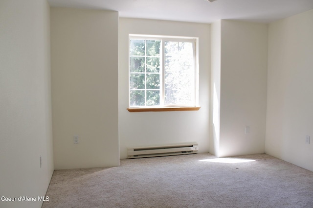 unfurnished room with a baseboard heating unit and carpet flooring