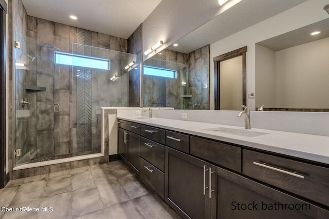 bathroom featuring vanity and an enclosed shower