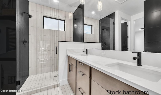 bathroom with tile walls, an enclosed shower, vanity, and tile patterned flooring