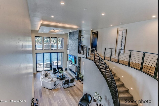 stairs featuring a high ceiling and wood-type flooring