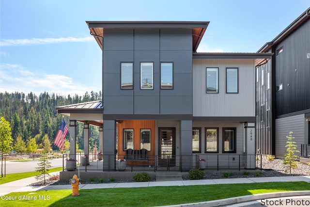 view of front of property featuring a porch, a standing seam roof, and metal roof