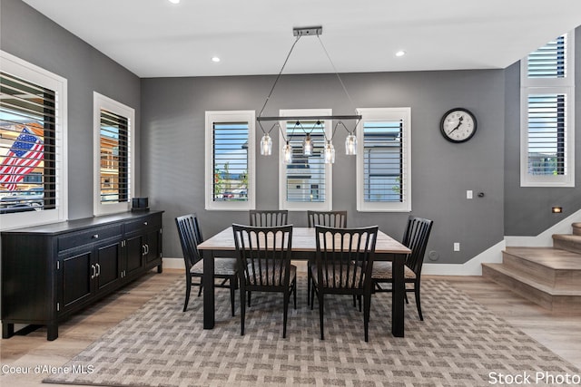 dining area featuring recessed lighting, baseboards, stairway, and light wood finished floors