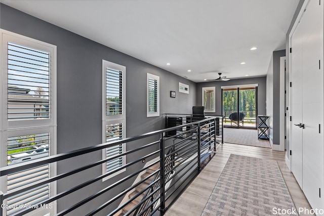 hallway with wood finished floors and recessed lighting