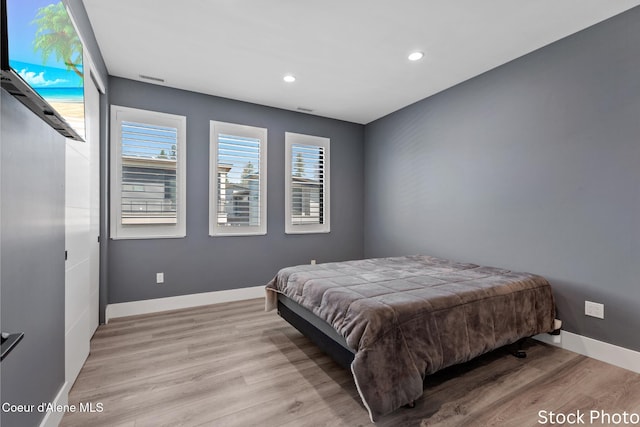 bedroom featuring recessed lighting, baseboards, and light wood finished floors