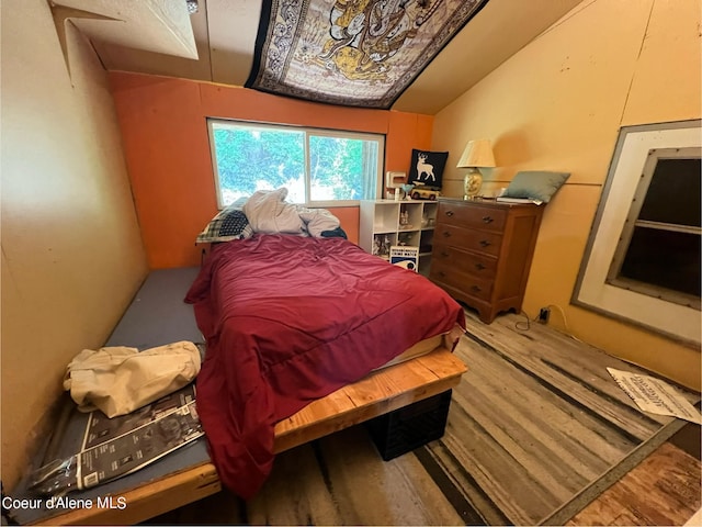 bedroom featuring lofted ceiling and hardwood / wood-style flooring