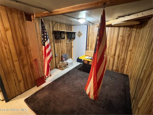 finished basement featuring wood walls