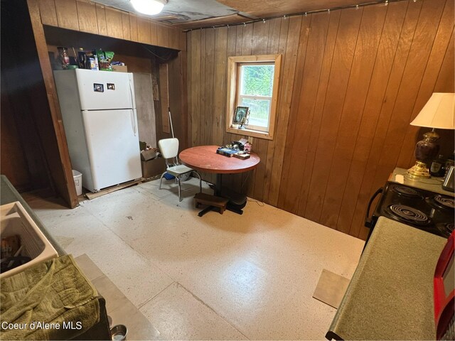 interior space with wood walls and tile patterned floors