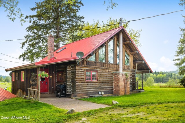 rear view of house with a yard