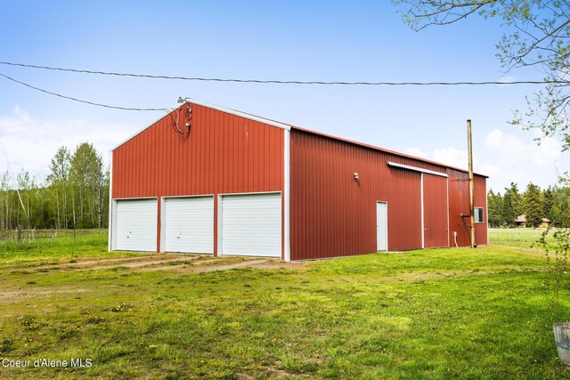 garage featuring a lawn