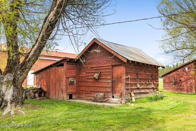 view of outdoor structure with a lawn