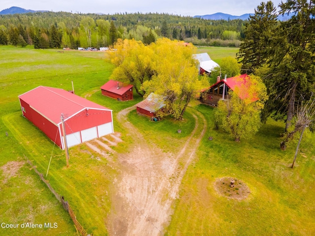 aerial view with a forest view, a mountain view, and a rural view