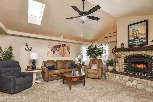 carpeted living area featuring a ceiling fan, lofted ceiling, and a stone fireplace