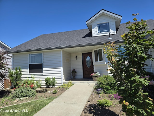 view of front of property featuring a shingled roof