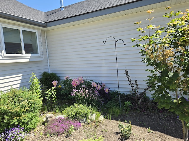 exterior space featuring roof with shingles