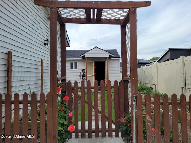 view of front facade with a gate, fence, and a pergola