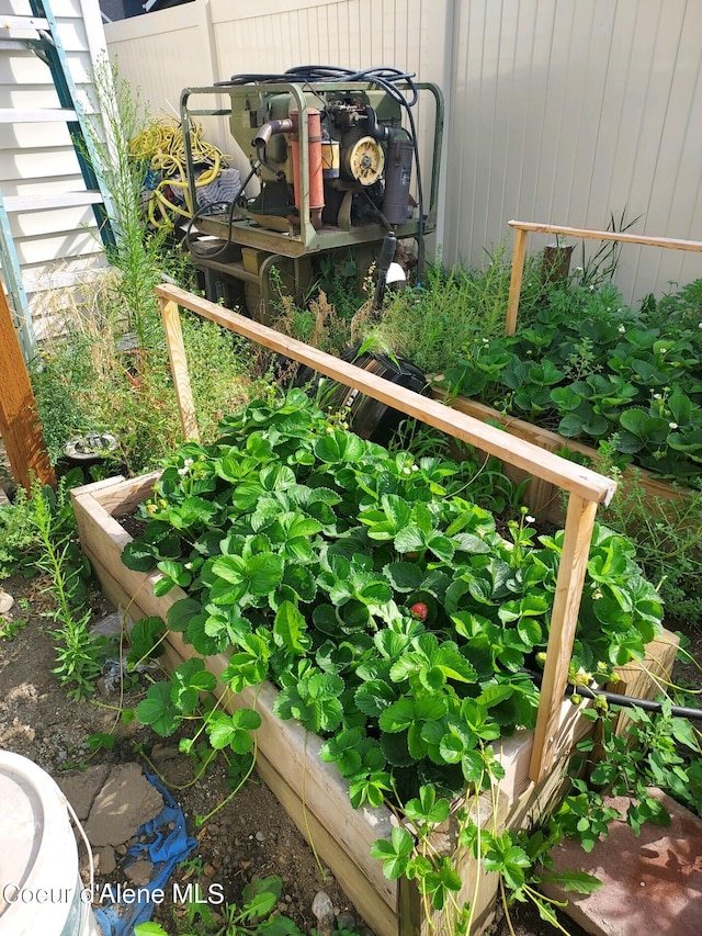 exterior details with a vegetable garden and fence