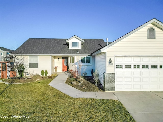 view of front of home featuring an attached garage, concrete driveway, and a front yard