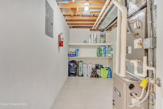 unfinished below grade area featuring tile patterned flooring and electric panel