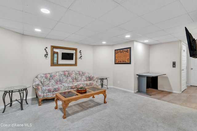 carpeted living area featuring recessed lighting, a paneled ceiling, and baseboards