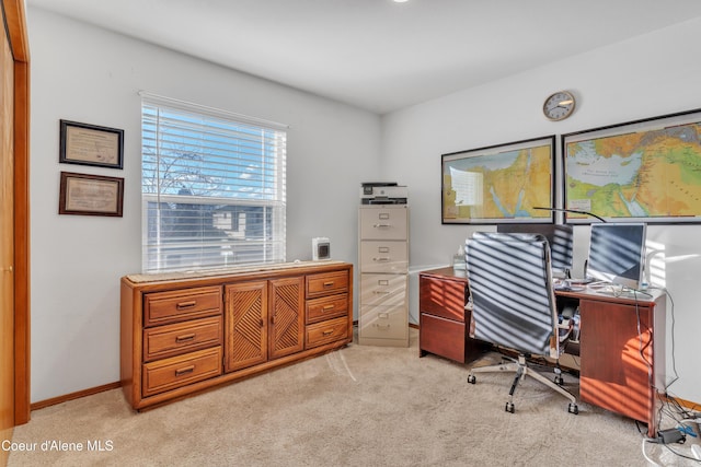 home office featuring baseboards and light colored carpet