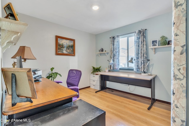 office space featuring light wood-style floors and baseboards