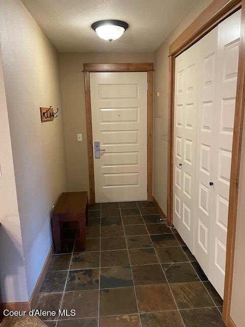 doorway with a textured ceiling