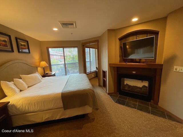 110 Morning Star Dr Unit 237, Kellogg, ID 83837 - carpeted bedroom featuring a tiled fireplace, recessed lighting, and visible vents