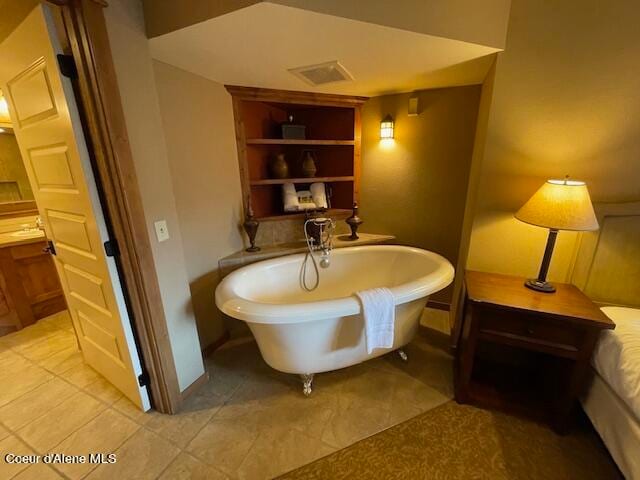 bathroom featuring tile patterned flooring and a tub to relax in