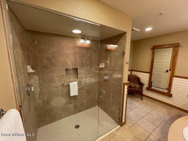 bathroom with tile patterned flooring and walk in shower