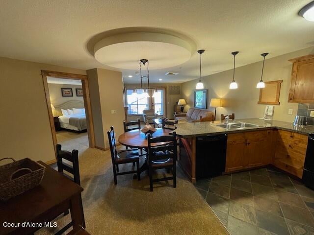 kitchen with kitchen peninsula, dishwasher, dark tile patterned flooring, decorative light fixtures, and sink